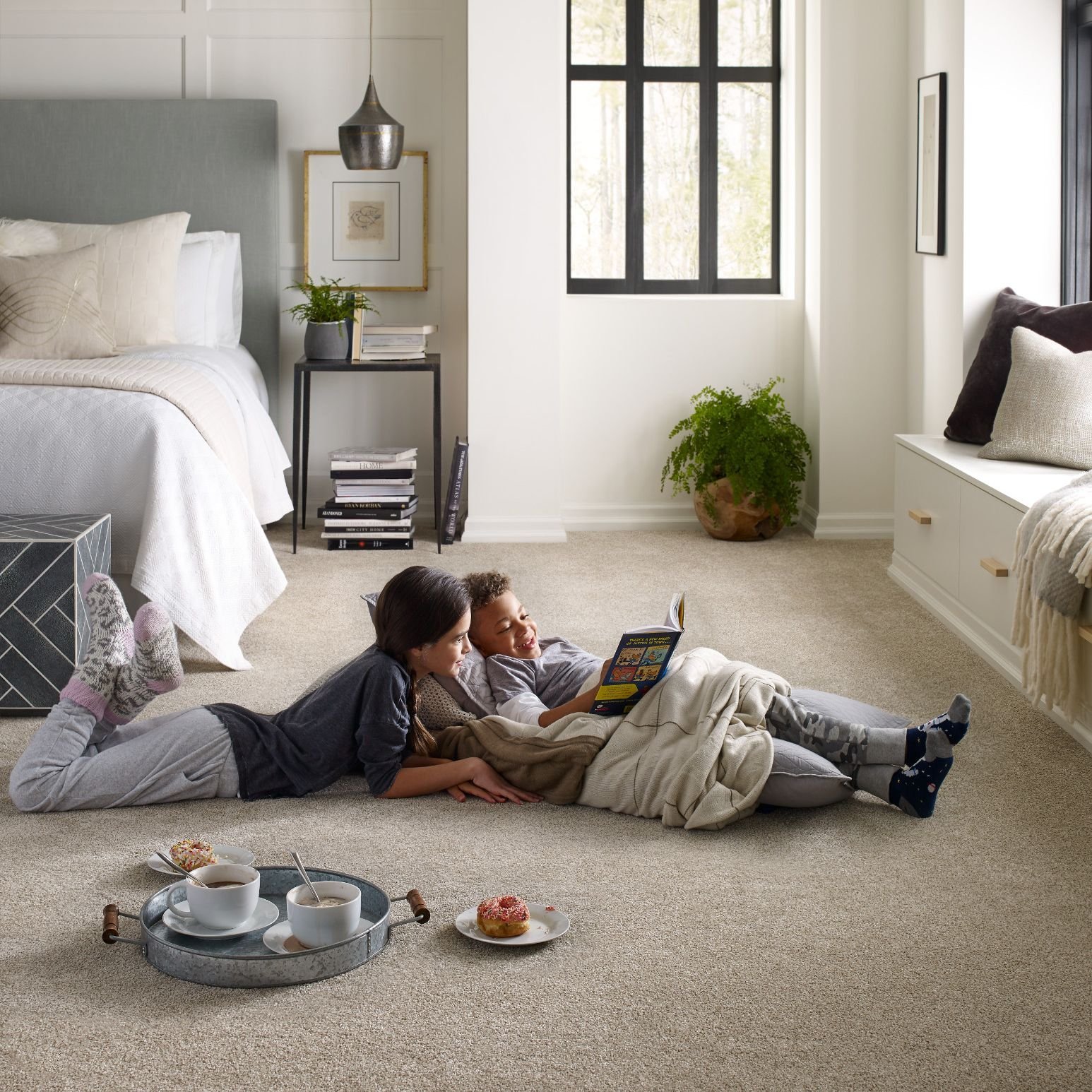 two people reading on a carpet bedroom floor - USA Carpets in GA